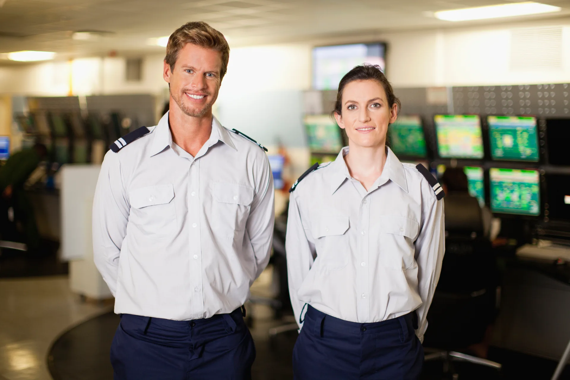 Two uniformed colleagues in an operations center